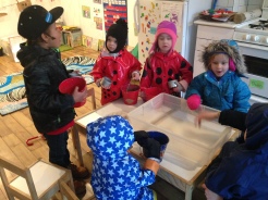 After snack, we got all dressed up in our rain gear. Then Lilly and I announced a special rainy day surprise: WE ARE PLAYING IN OUR BACKYARD TODAY! We thought it would be fun to make mud pies.